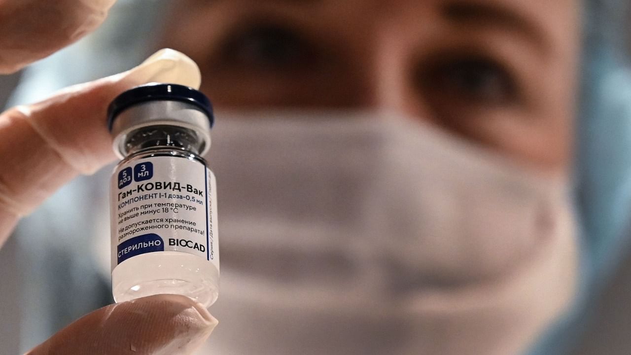 A medical worker holds a vial with Russia's Sputnik V (Gam-Covid-Vac) vaccine against the Covid-19 at a vaccination point at the GUM department store in Moscow. Credit: AFP File Photo