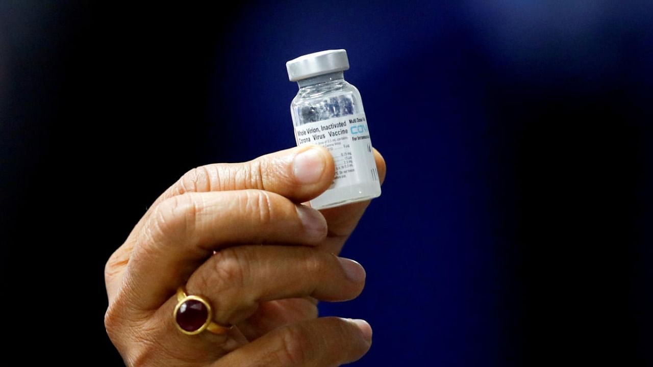 Indian Health Minister Harsh Vardhan holds a dose of Bharat Biotech's Covid-19 vaccine called Covaxin, during a vaccination campaign at All India Institute of Medical Sciences (AIIMS) hospital in New Delhi. Credit: Reuters.
