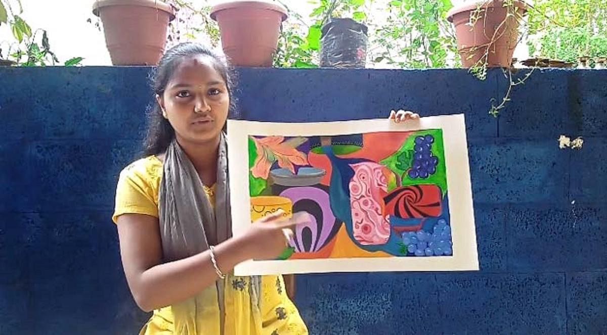 S R Akshatha with an artwork made by her at Navagrama in Kodlipete.