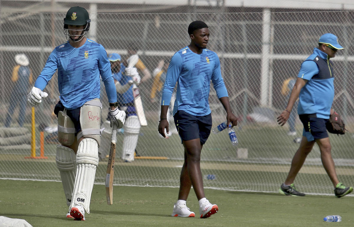  South Africa's Dean Elgar, left, and Lutho Sipamla, center, attend a practice session at the National Cricket Stadium, in Karachi, Pakistan. Credit: AP. 