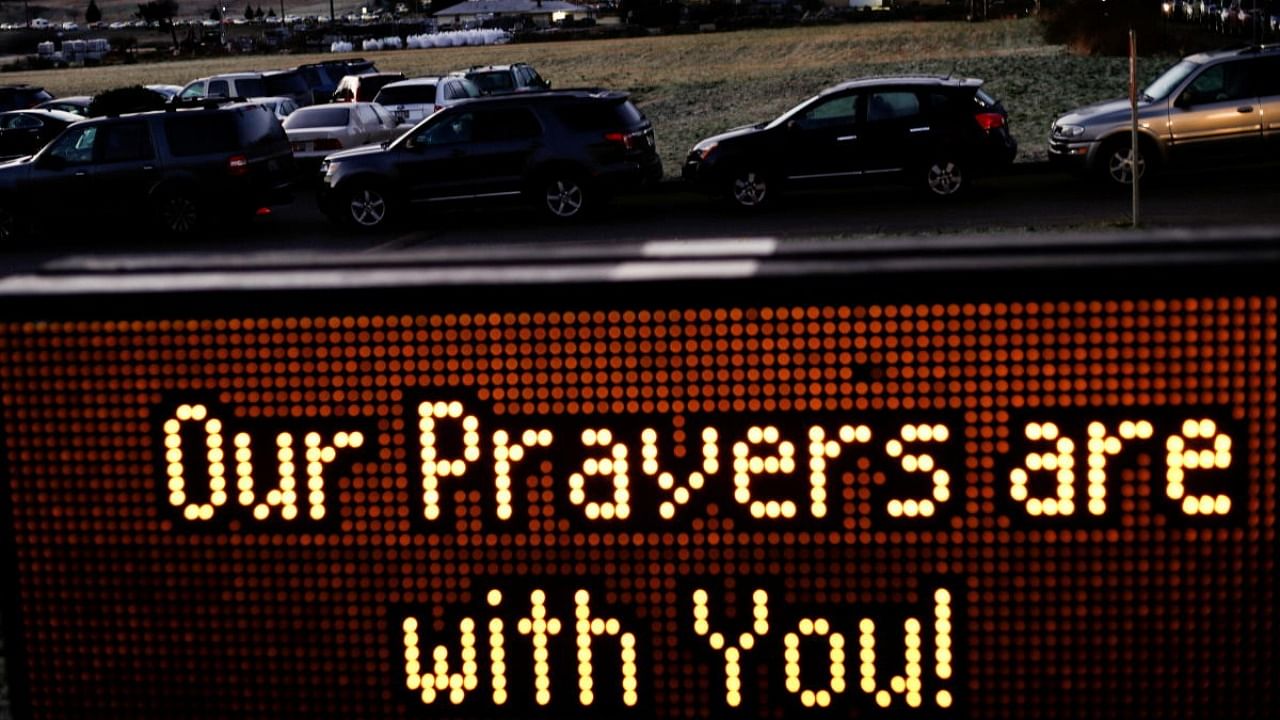 An LED sign at the Trinity United Methodist Church displays a message as hundreds line up early to wait for a free drive-through coronavirus vaccine clinic for people 70 and older and their spouse or partner, run by the Jamestown S'Klallam Tribe in Sequim, Washington. Credit: Reuters.