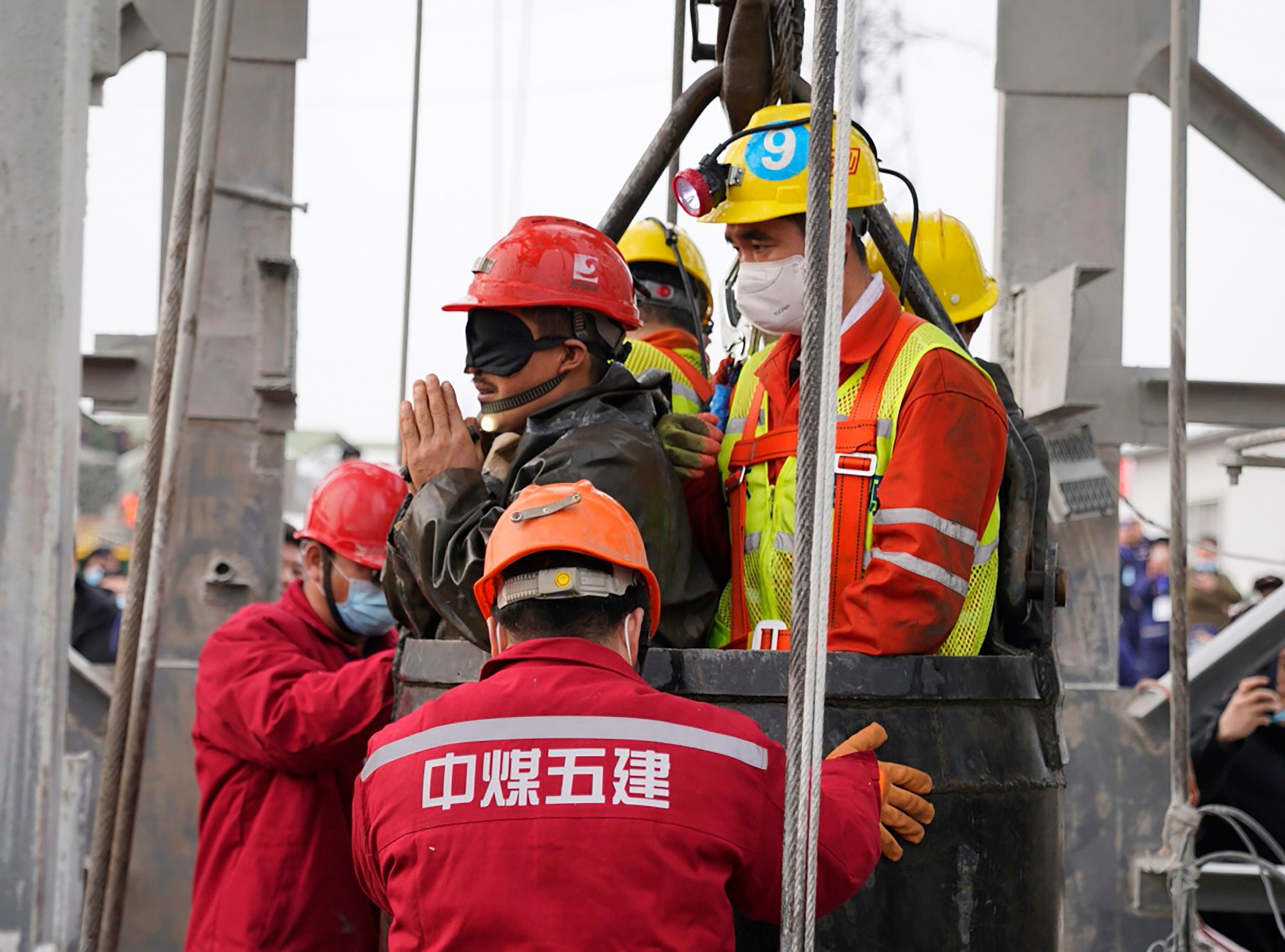 One of twenty-two Chinese miners wearing a black patch is saved from hundreds of metres underground, where they had been trapped for two weeks after a gold mine explosion in Qixia, in eastern China's Shandong province. Credit: AFP Photo
