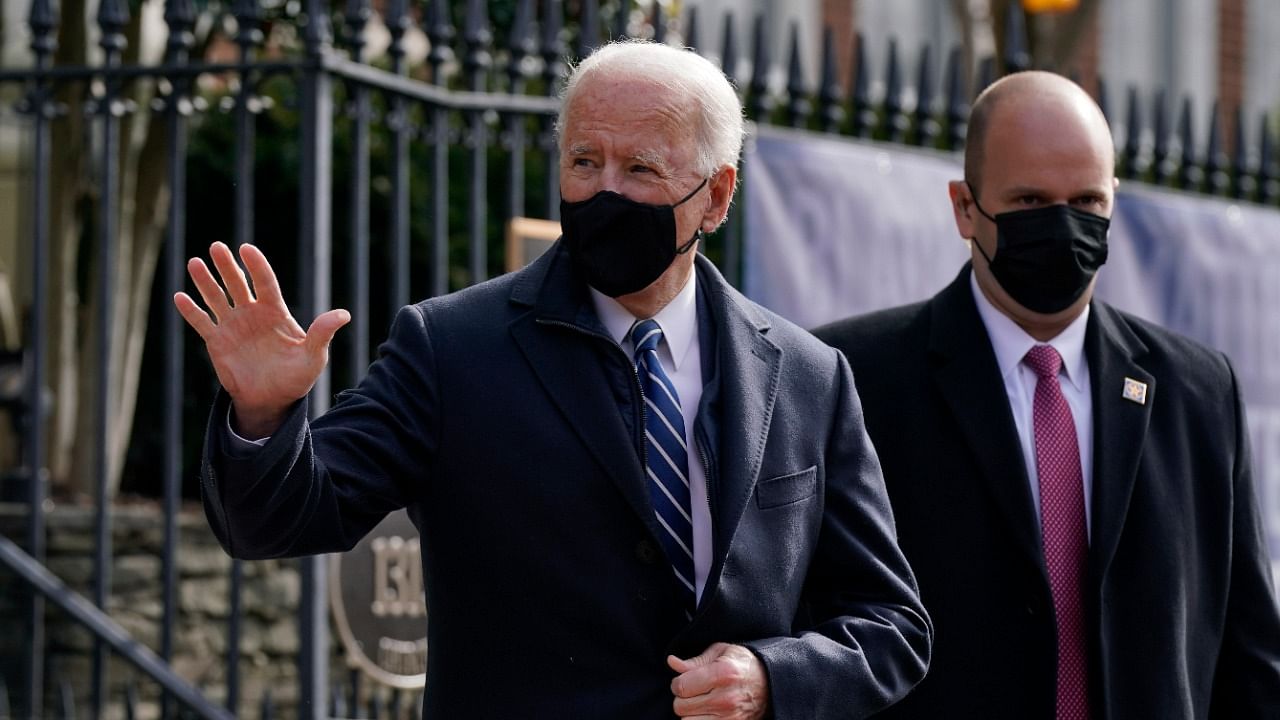 :President Joe Biden waves as he departs after attending Mass at Holy Trinity Catholic Church. Credit: AP/PTI Photo