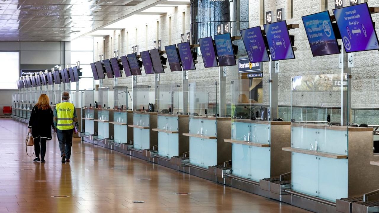 This picture taken on January 24, 2021 shows a view of the empty departure check-in counter for Israel flag carrier El Al at Israel's Ben Gurion Airport in Lod, east of Tel Aviv. Credit: AFP.