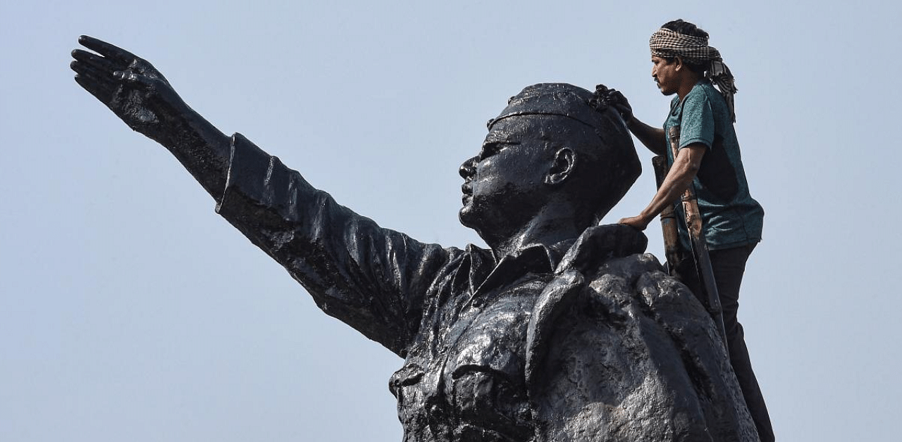 A worker paints a statue of Netaji Subash Chandra Bose in Kolkata. Credit: PTI. 
