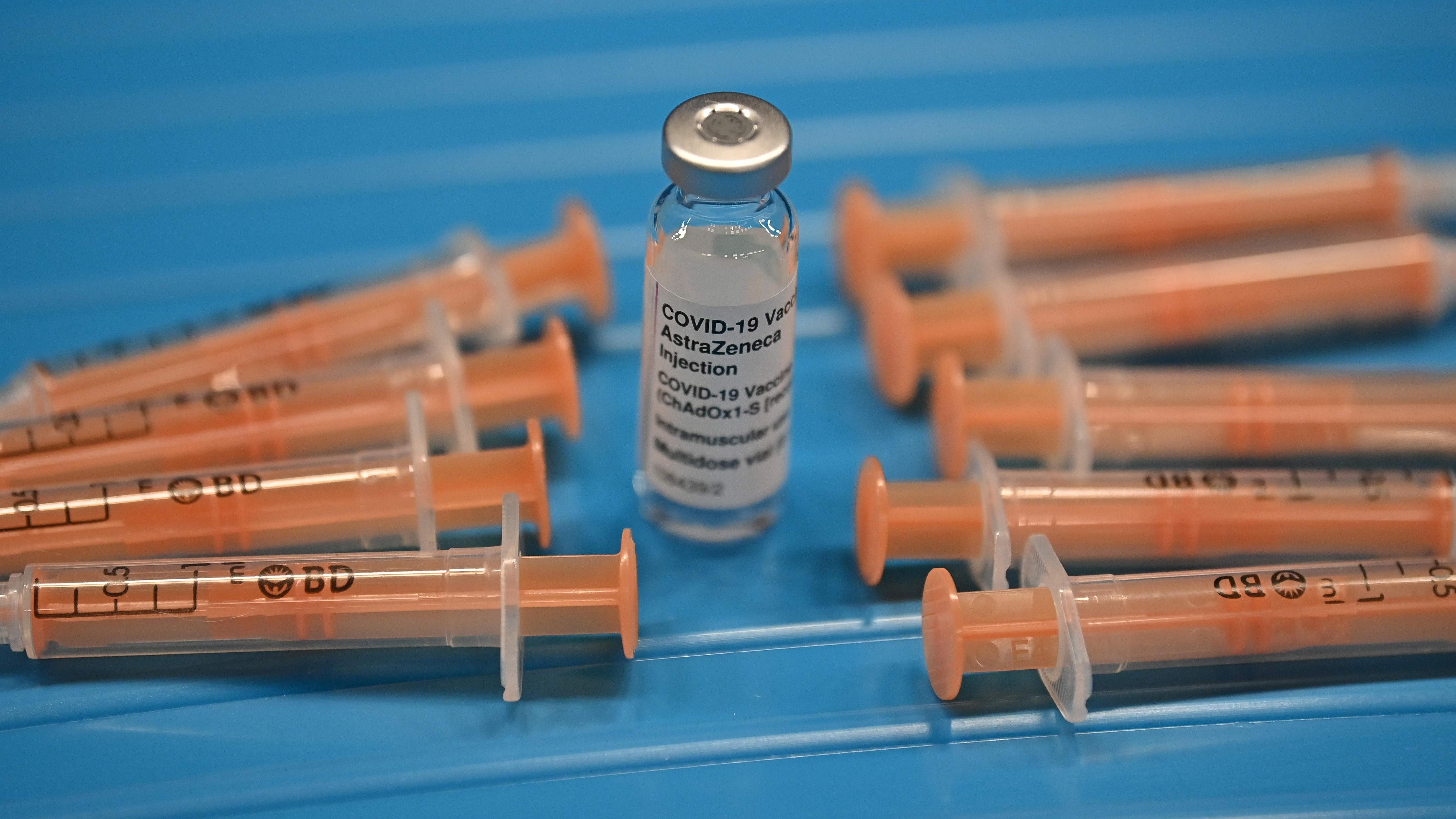 A posed photograph taken as an illustration shows syringes arranged around a used vial of the Oxford/AstraZeneca Covid-19 vaccine at the vaccination centre. Credit: AFP