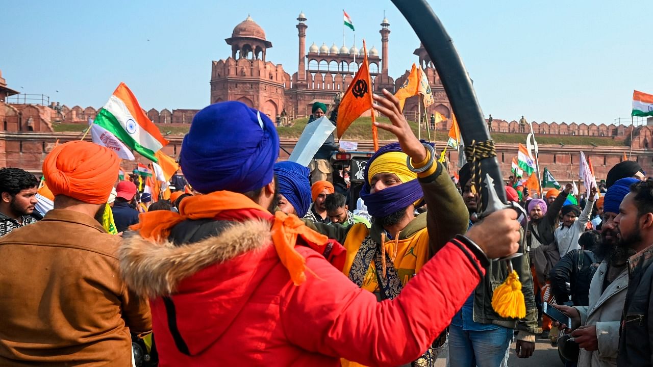 Protesting farmers shout slogans in front of the Red Fort as farmers continue to protest against the central government's recent agricultural reforms in New Delhi on January 26, 2021. Credit: AFP Photo