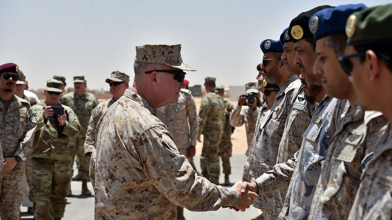 US Marine Corps General Kenneth F. McKenzie Jr. (C-L), Commander of the US Central Command (CENTCOM), shakes hands with Saudi military officers during his visit to a military base in al-Kharj in central Saudi Arabia. Credit: AFP Photo