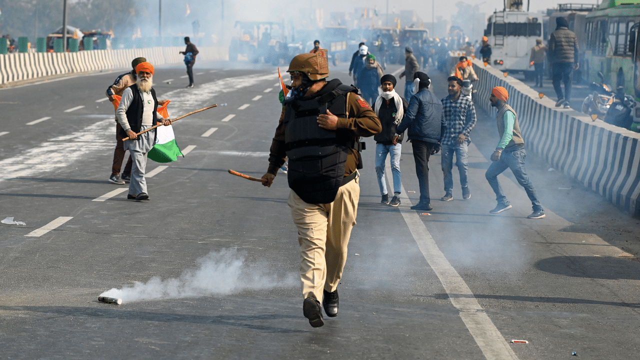 Police fire tear gas to disperse farmers during a tractor rally as they continue to demonstrate against the central government's recent agricultural reforms in New Delhi. Credit: AFP Photo