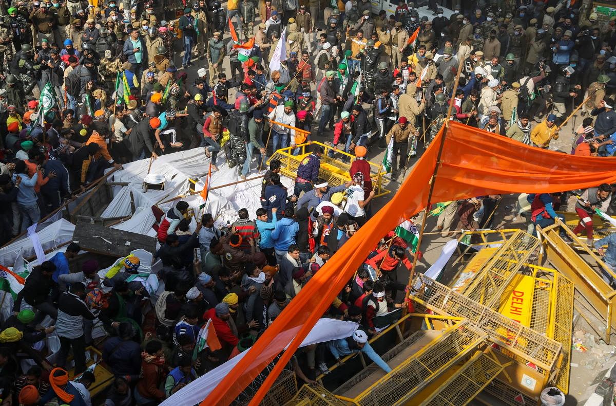 Farmers move barricades during the tractor rally. Credit: Reuters photo. 