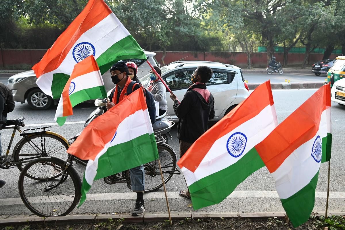 A vendor sells Indian national flags at a roadside on the eve of the country's Republic Day celebrations in New Delhi on January 25, 2021. Credit: AFP Photo