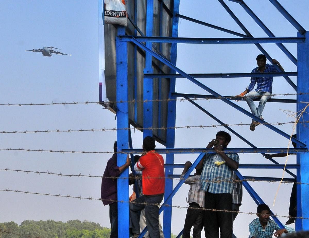 In the past, aviation buffs kept out of the Yelahanka Air Base would watch the air show from highrise rooftops and treetops outside the venue’s periphery. Credit: DH Photo