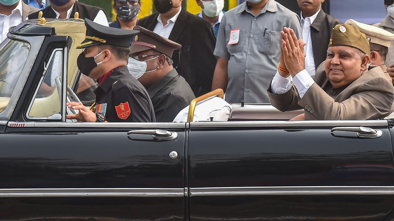 West Bengal Governor Jagdeep Dhankar greets the crowd as he arrives to attend the 72nd Republic Day parade at Red Road in Kolkata. Credit: PTI Photo