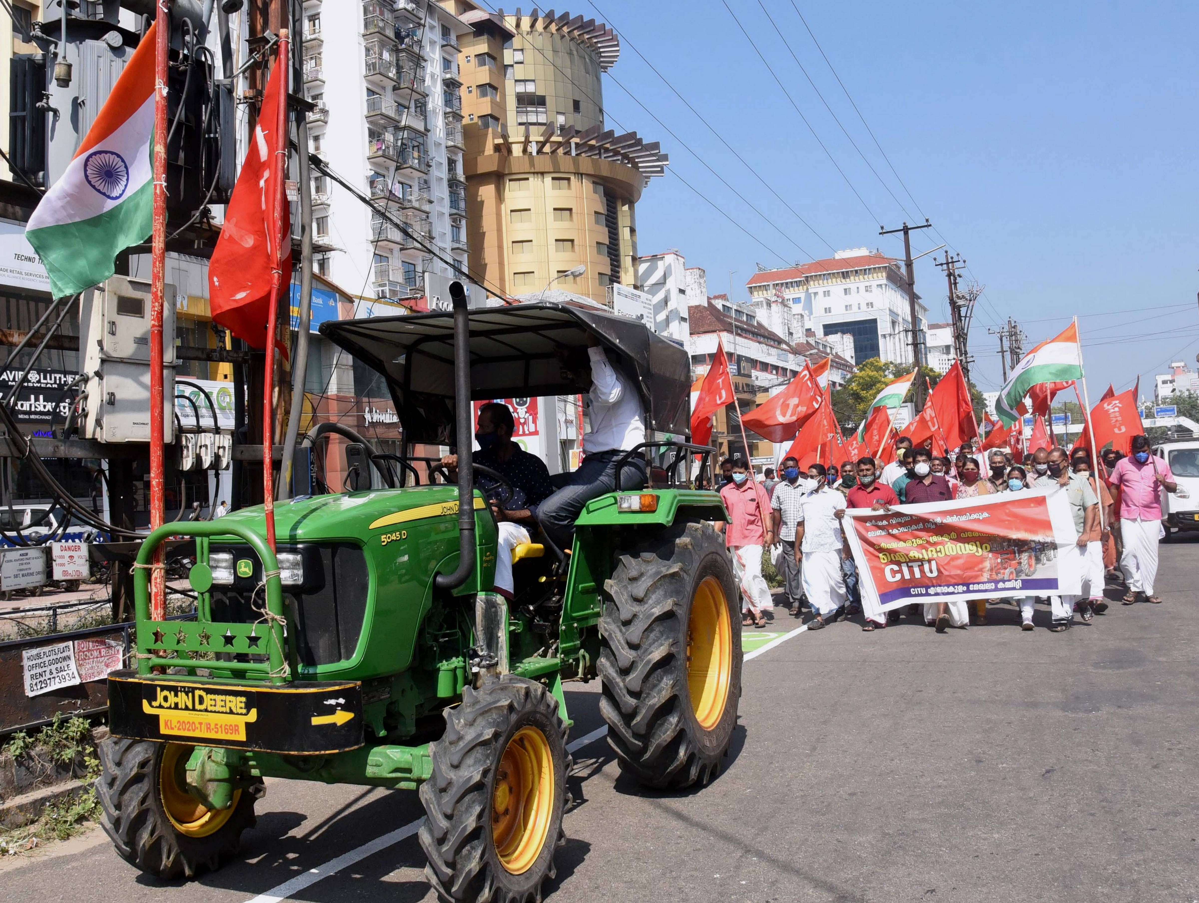 Centre of Indian Trade Unions (CITU) members take part in a rally in solidarity with farmers' tractor rally on Republic Day, in Kochi, Tuesday, Jan. 26, 2021. Credit: PTI Photo