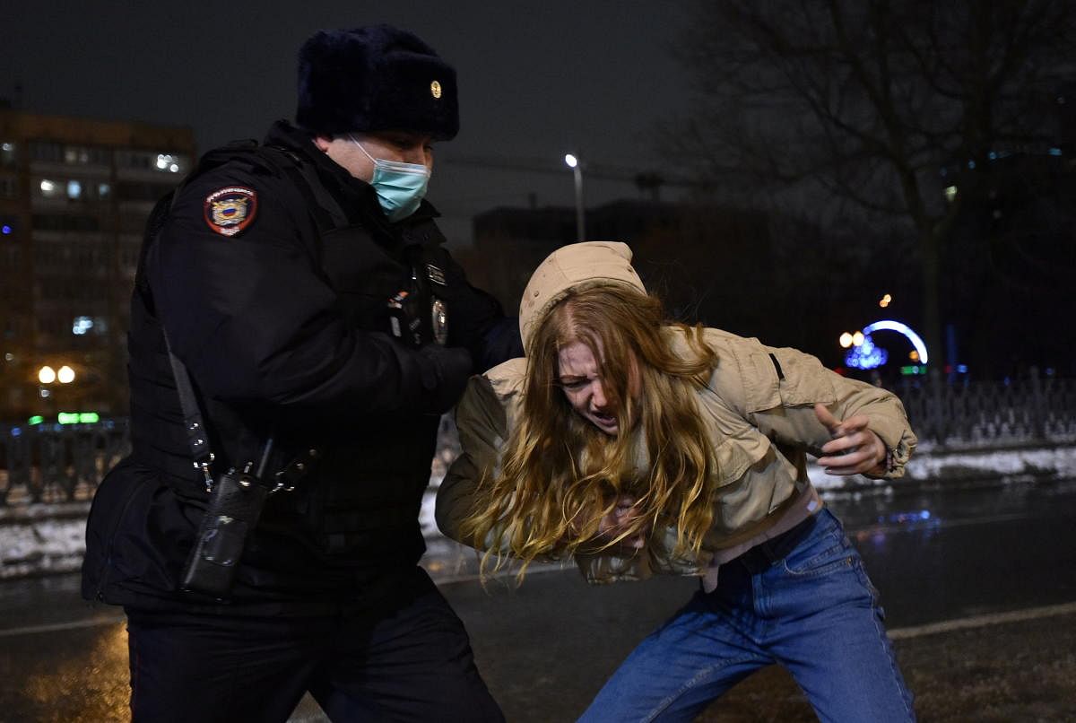 A law enforcement officer detains a woman during a rally in support of jailed Russian opposition leader Alexei Navalny in Moscow, Russia January 23, 2021. Credit: REUTERS