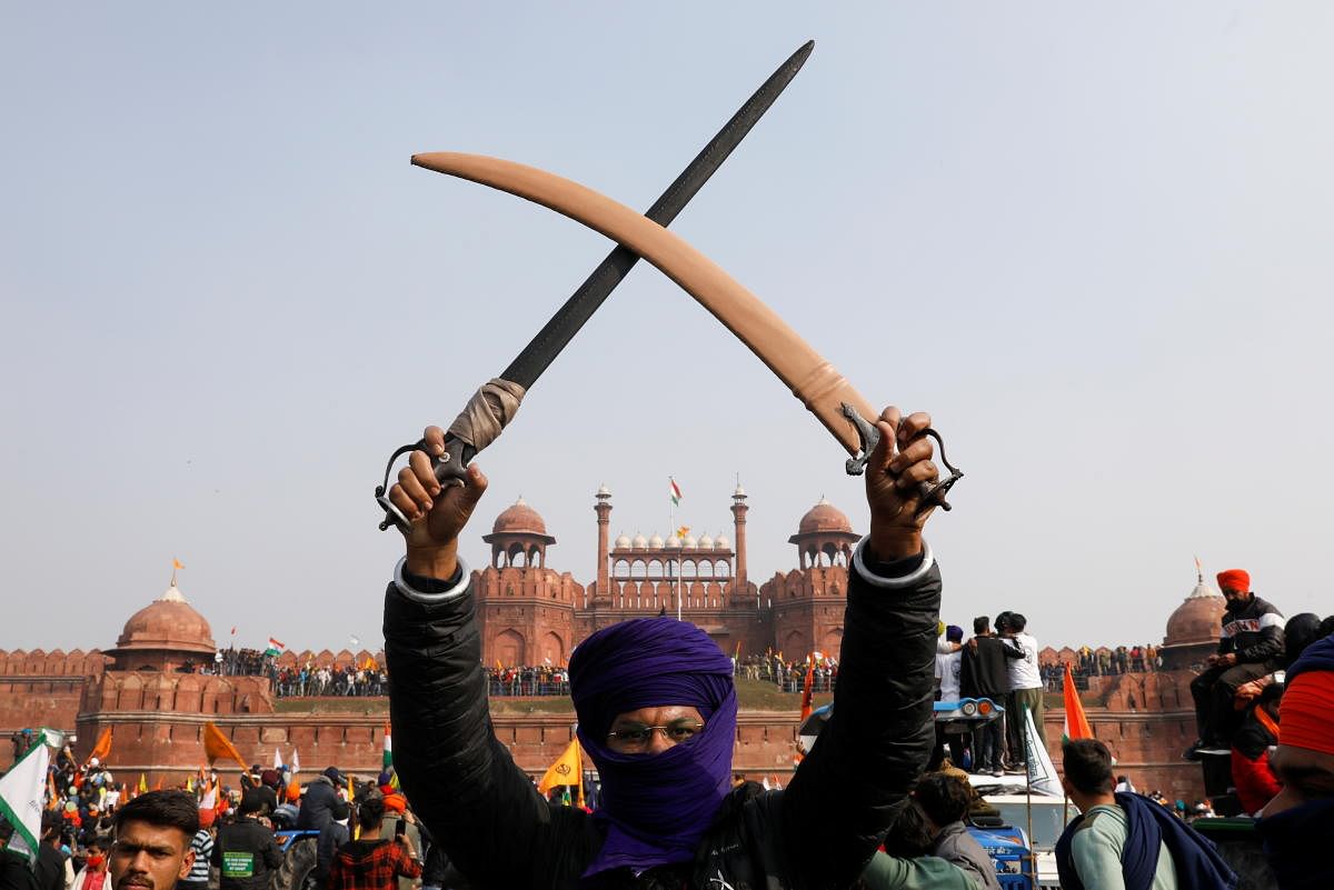 A farmer holds a sword during a protest against farm laws introduced by the government, at the historic Red Fort in Delhi, India, January 26, 2021. Credit: REUTERS