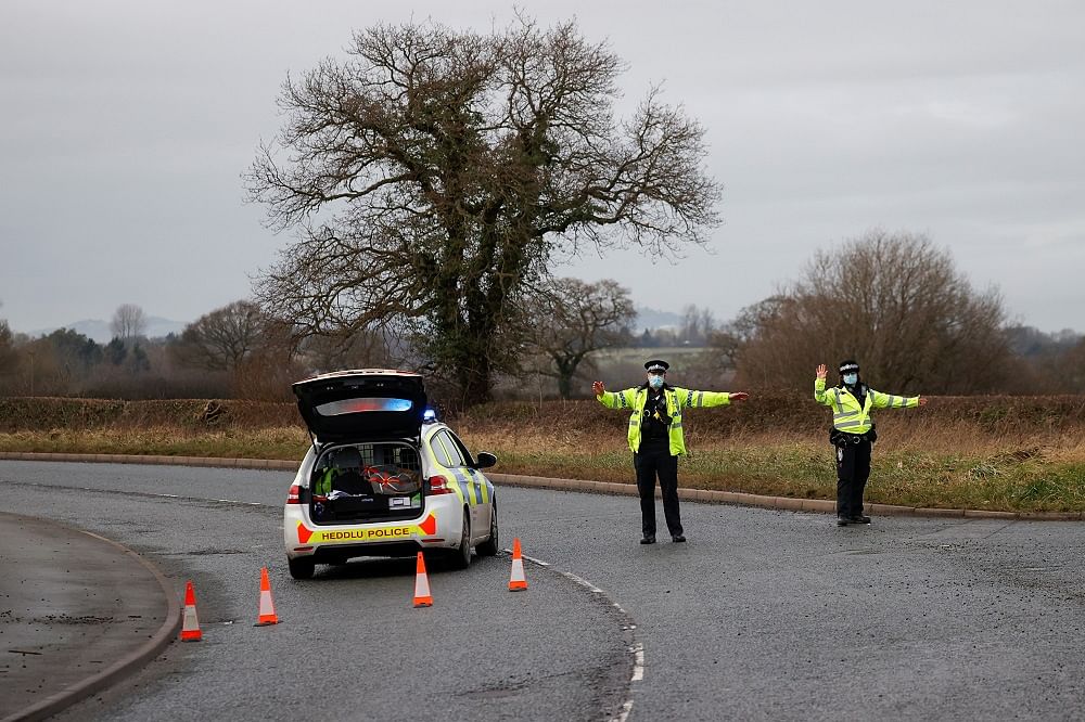 Police officers manage a checkpoint on a road near the Wockhardt pharmaceutical plant in Wrexham, Britain. Credit: Reuters Photo