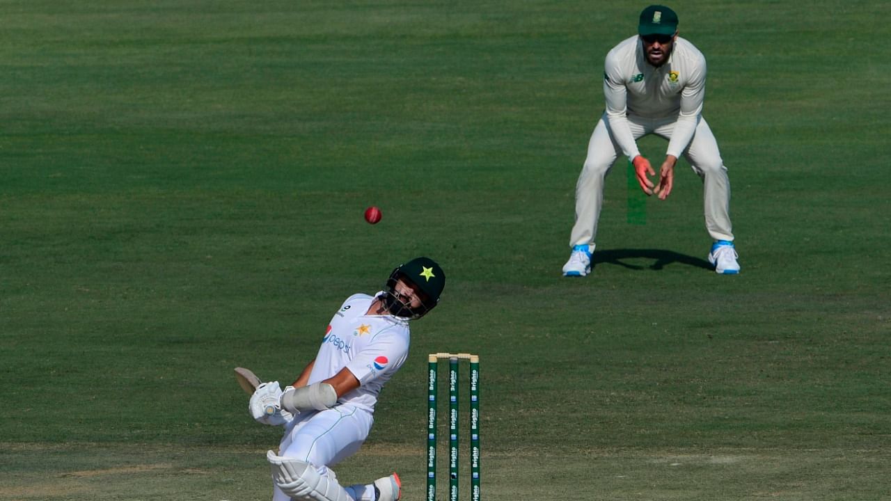 Pakistan's Azhar Ali (bottom C) avoids the ball during the second day of the first cricket Test match between Pakistan and South Africa at the National Stadium in Karachi on January 27, 2021. Credit: AFP Photo