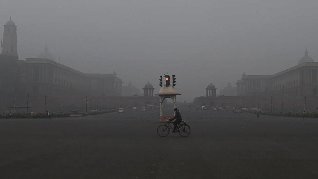  A man rides cycle near the Vijay Chowk, amid a cold and foggy winter morning in New Delhi. Credit: PTI File Photo