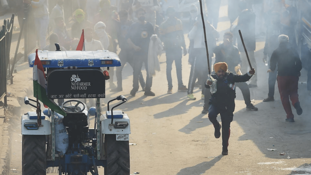  Security personnel use teargas shells to disperse farmers during clashes after their tractor rally turned violent, in New Delhi, Tuesday, Jan 26, 2021. Credit: PTI Photo