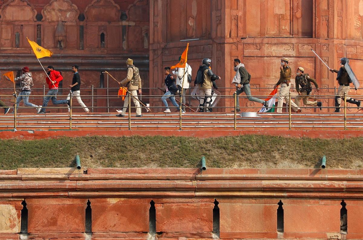 Demonstrators run as police officers chase them during a protest against farm laws introduced by the government, at the historic Red Fort in Delhi, India, January 26, 2021. Credit: REUTERS Photo