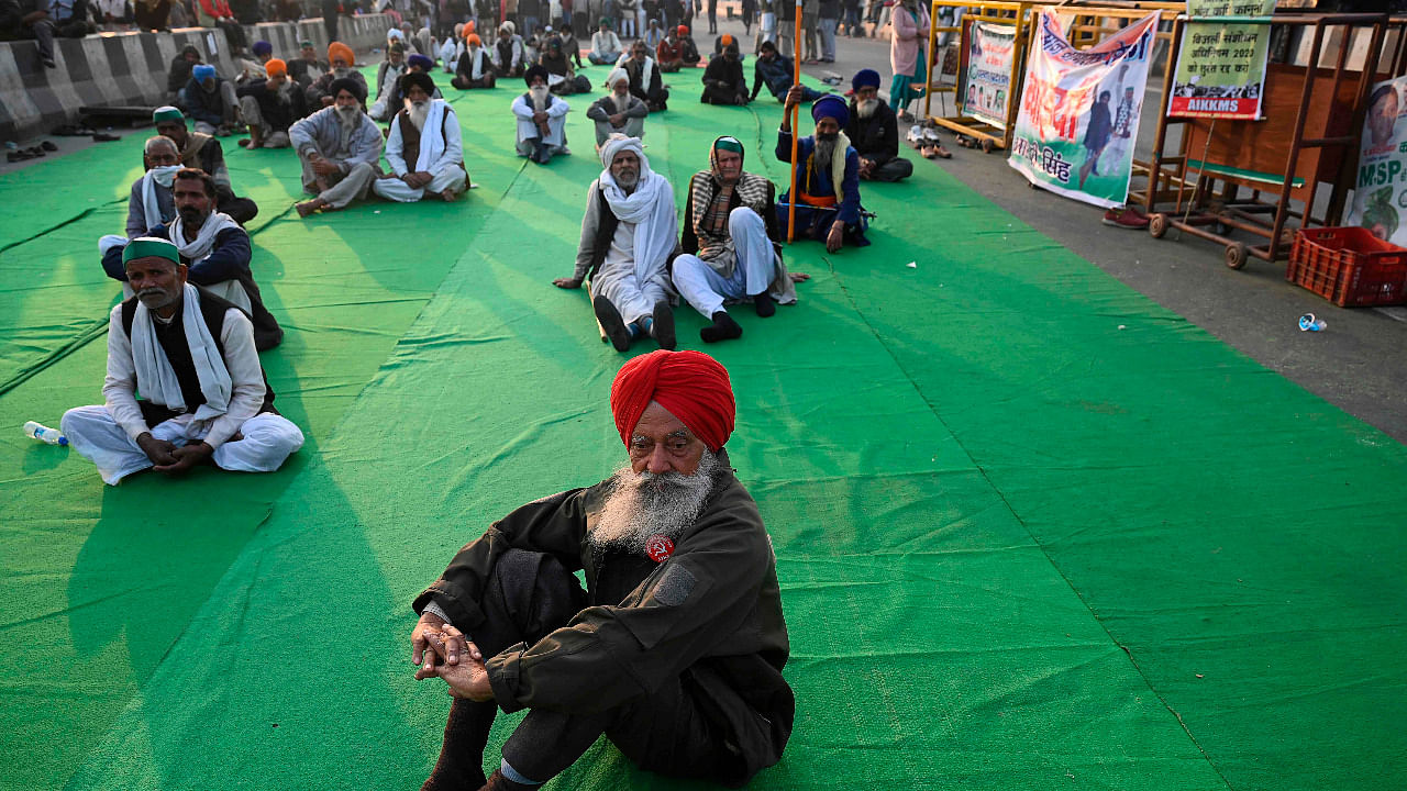Farmers listen to a speaker as they continue to protest against the central government's recent agricultural reforms, at Delhi-Uttar Pradesh state border in Ghazipur. Credit: AFP Photo