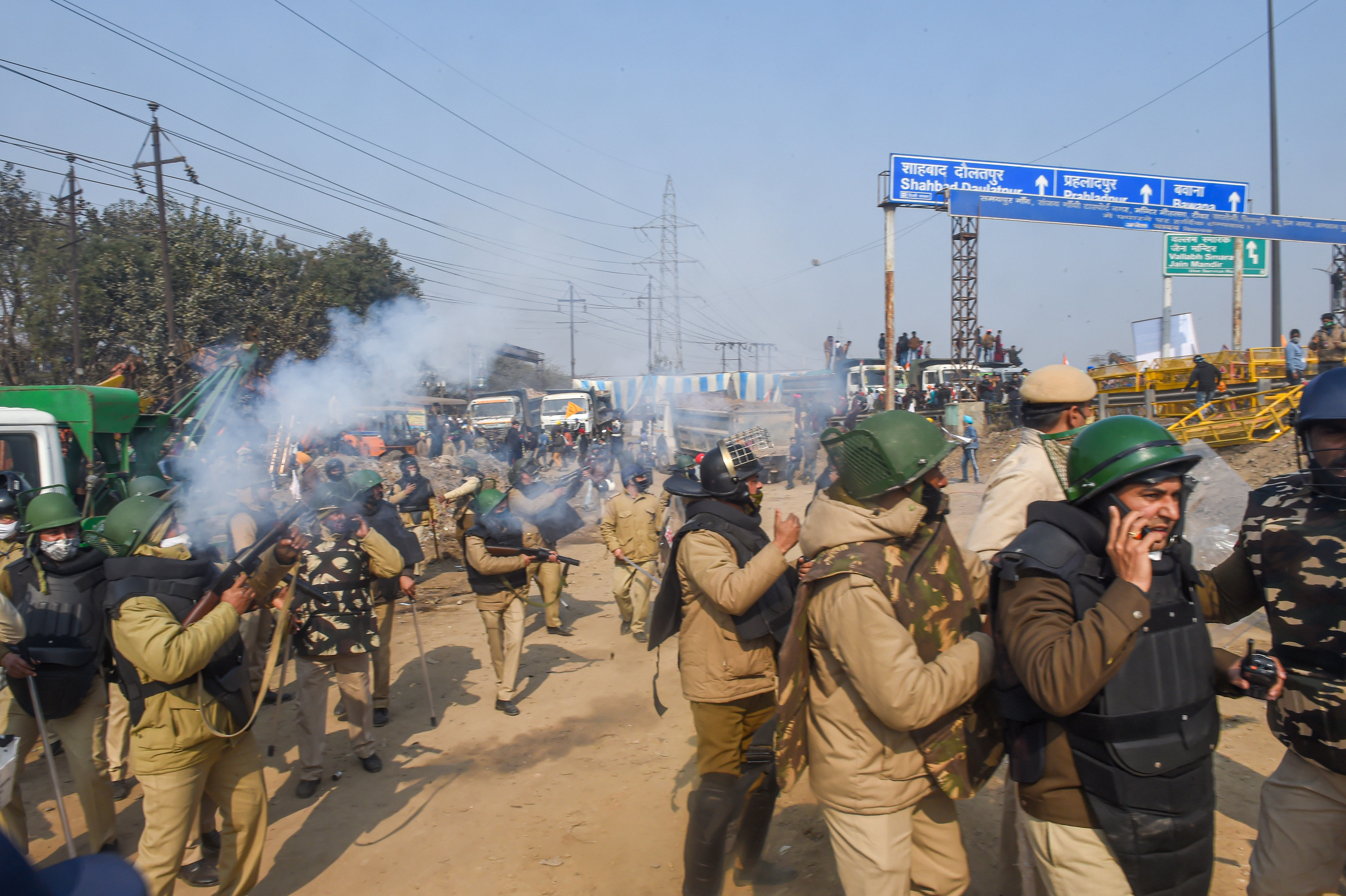 Police uses tear gas to disperse farmers attempting to break barricades as they try to march towards ISBT during the 'Kisan Gantantra Parade' amid the 72nd Republic Day celebrations, in New Delhi, Tuesday, Jan. 26, 2021. Credit: PTI Photo