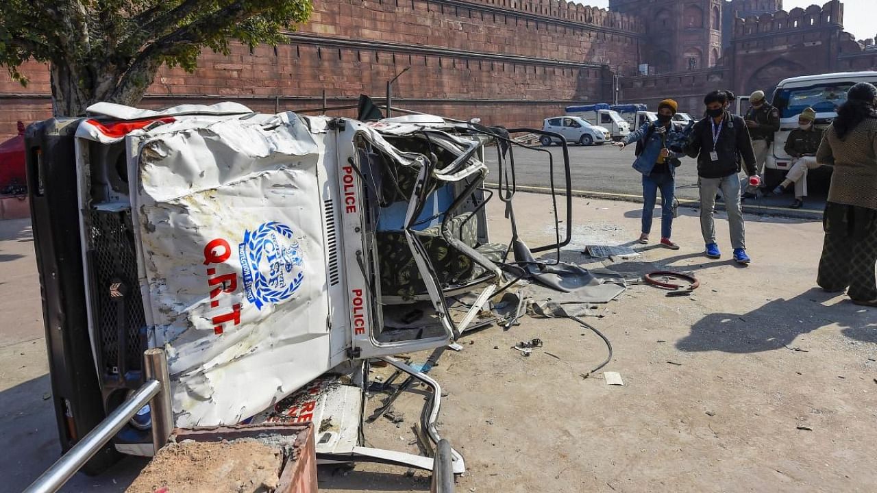 A damaged police jeep in the premises of Red Fort, a day after it was stormed by protesting farmers during their tractor march, in Delhi. Credit: PTI.