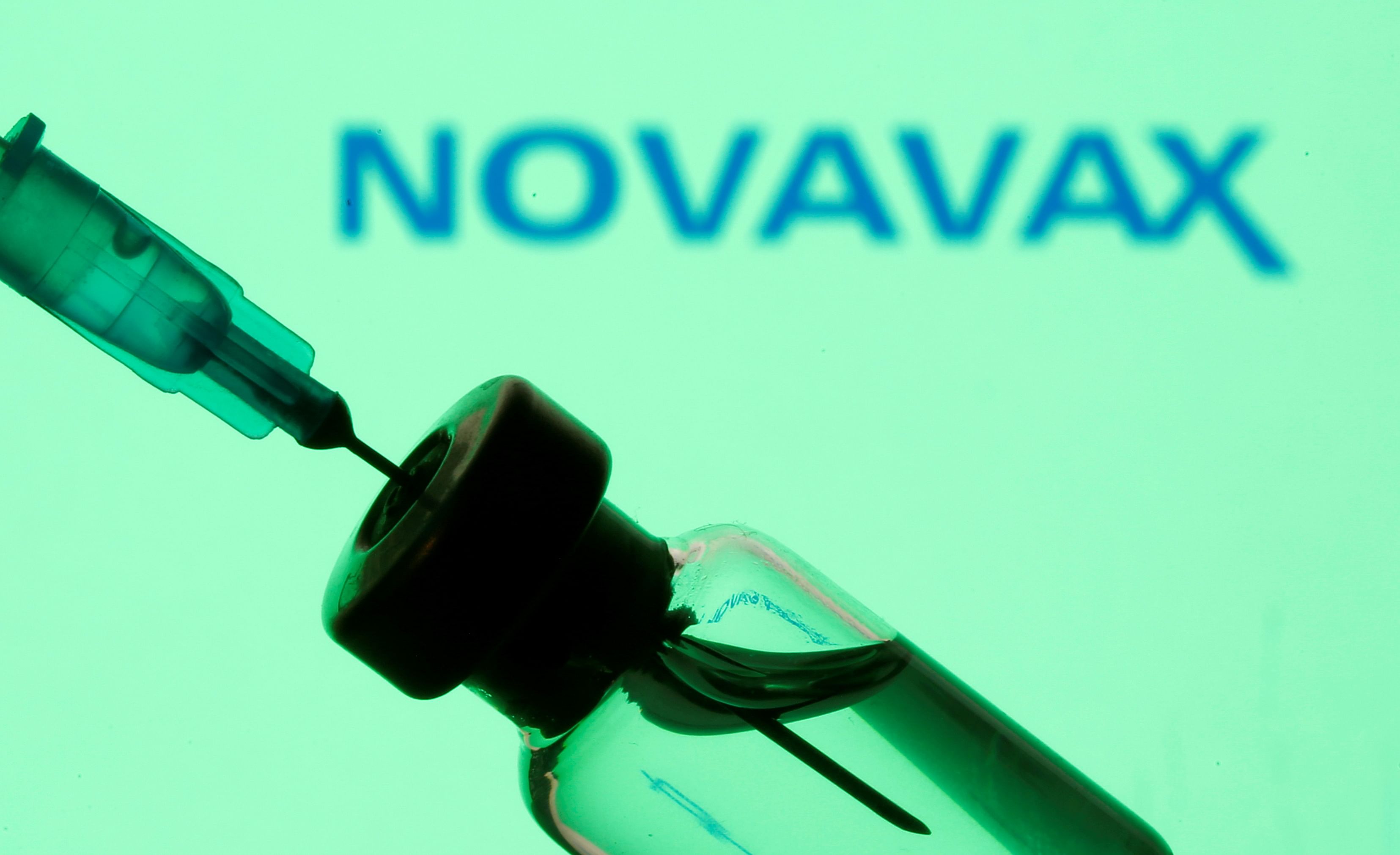 Vial and sryinge are seen in front of displayed Novavax logo. Credit: Reuters Photo