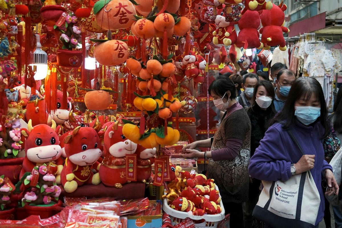 Customers wearing face mask shop for decorations, ahead of the Chinese Lunar New Year, following the coronavirus disease (COVID-19) outbreak, in Hong Kong, China January 28, 2021. Credit: REUTERS