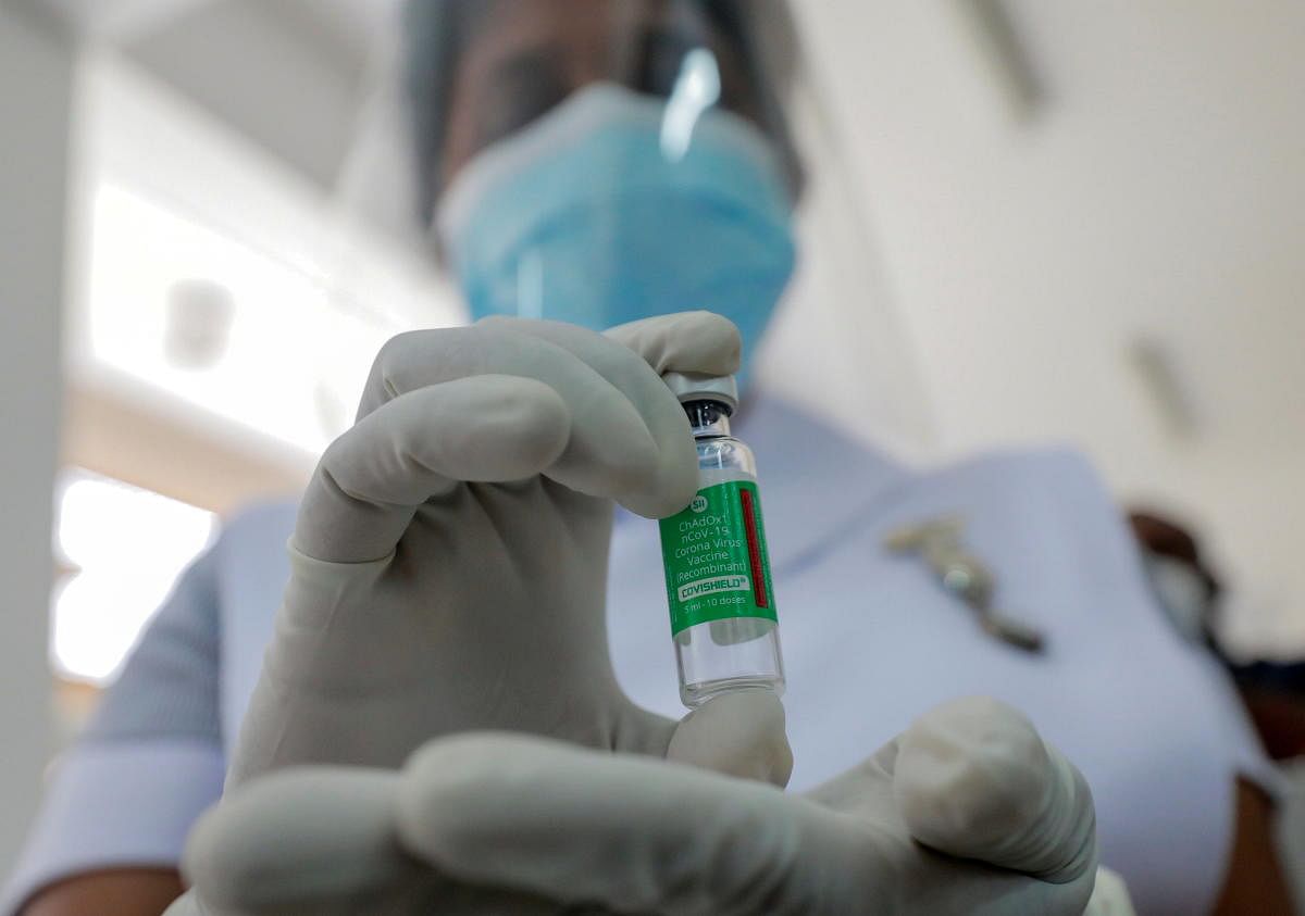 A Health official shows a bottle with a dose of the AstraZeneca's COVID-19 vaccine manufactured by the Serum Institute of India, at Infectious Diseases Hospital in Colombo, Sri Lanka January 29, 2021. Credit: REUTERS