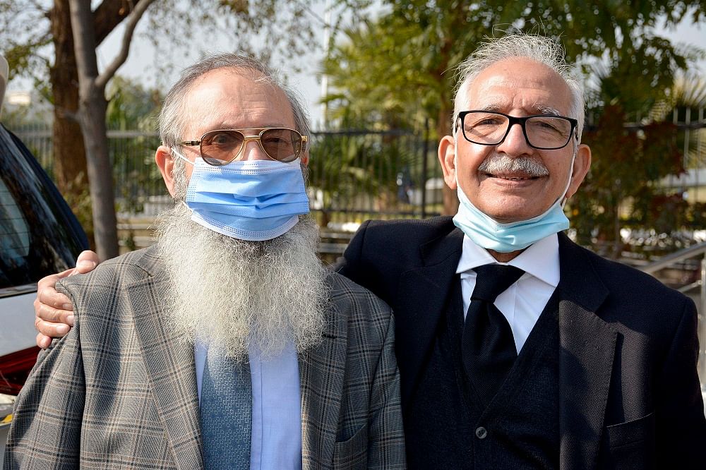 Mehmood A. Sheikh, right, defense lawyer, and Ahmed Saeed Sheikh, father of British-born Pakistani Ahmed Omar Saeed Sheikh, arrive at the Supreme Court for an appeal hearing in the Daniel Pearl case. Credit: AP Photo