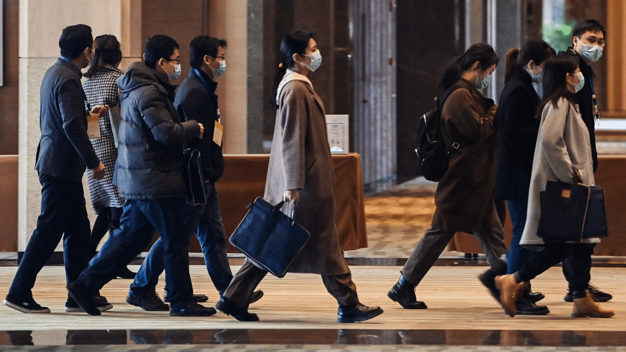 Chinese officials arrive for meetings with the World Health Organization (WHO) team investigating the origins of the Covid-19 pandemic at the Hilton Wuhan Optics Valley Hotel in Wuhan. Credit: AFP Photo