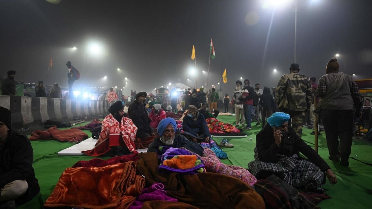 Farmers sit on a blocked highway as they continue to protest against the central government's recent agricultural reforms, at Delhi-Uttar Pradesh state border in Ghazipur. Credit: AFP.