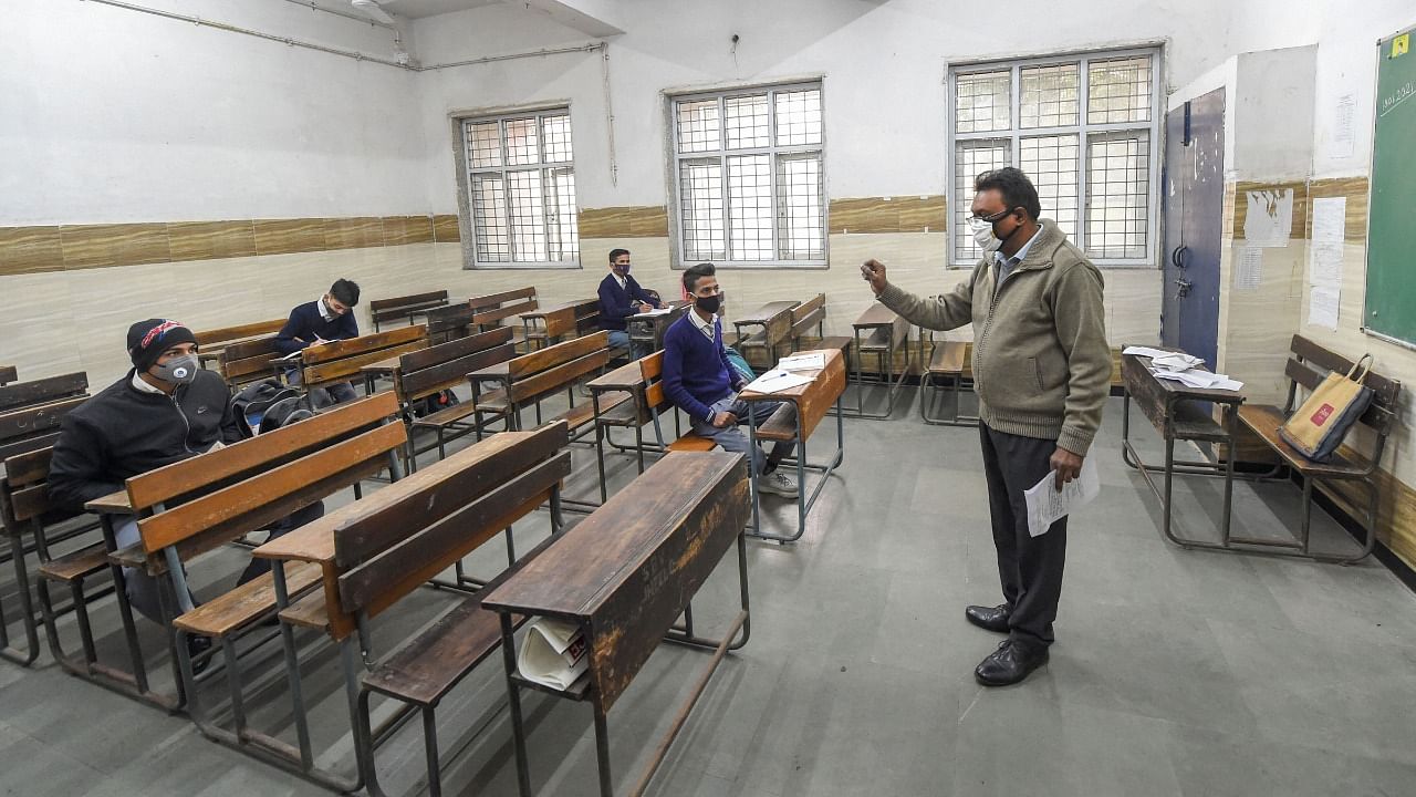  A teacher takes a class at a Rajkiya Sarvodaya Bal Vidyalaya, as schools in the national capital reopened for students of class 10 and 12. Credit: PTI File Photo
