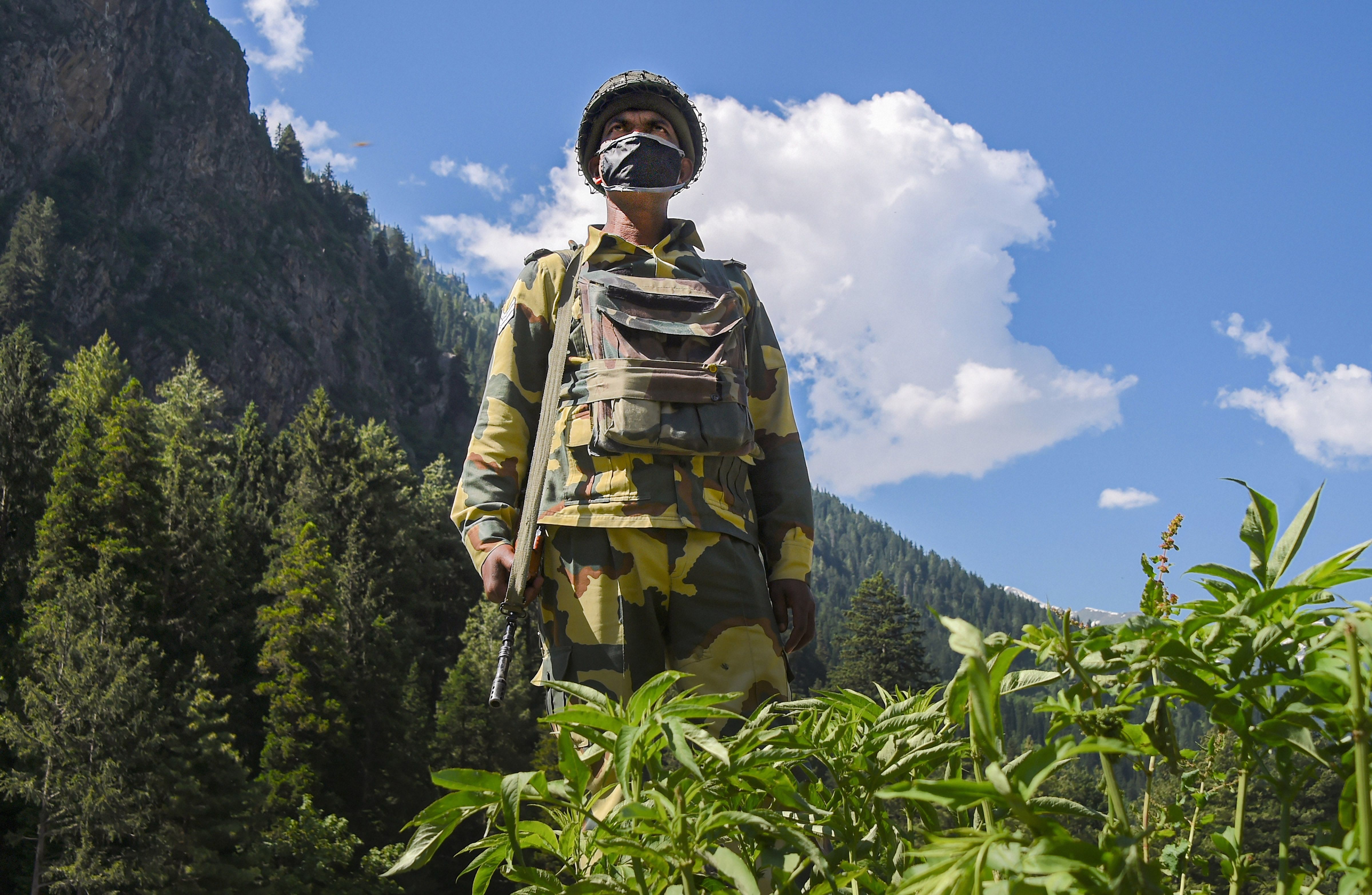 A Border Security Force (BSF) personnel stands guard along the Srinagar-Leh National highway, in Ganderbal district of Central Kashmir, Wednesday, June 17, 2020. Representative image/Credit: PTI File Photo