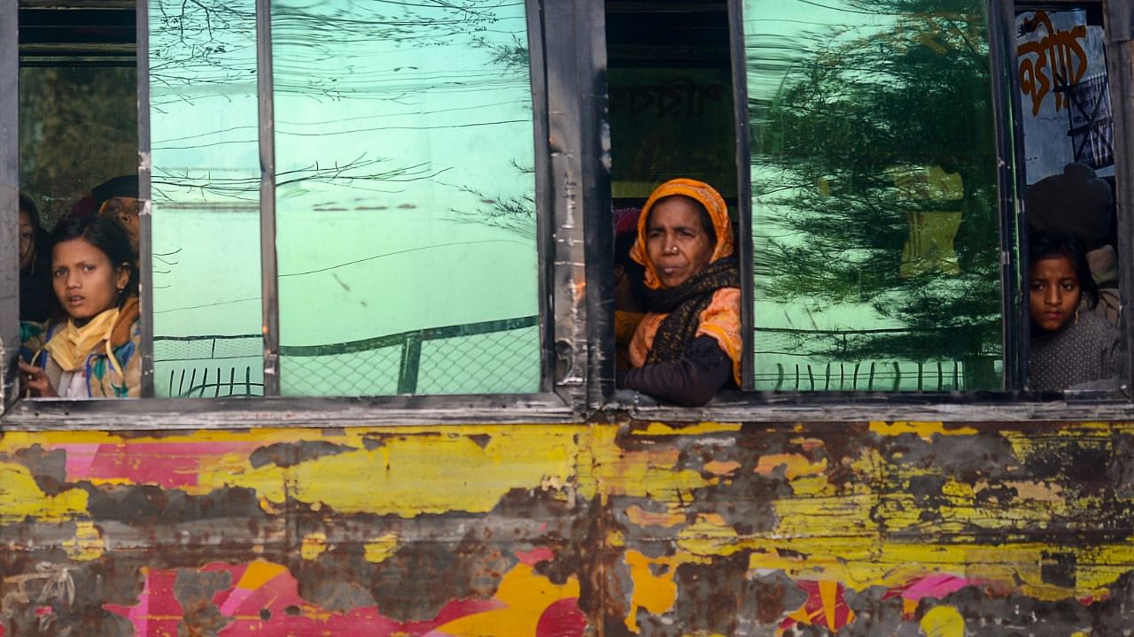 Rohingya refugees look out from a bus headed to a Bangladeshi navy ship in Chittagong on January 30, 2021, that will take them to be relocated to Bhashan Char island in the Bay of Bengal. Credit: AFP Photo