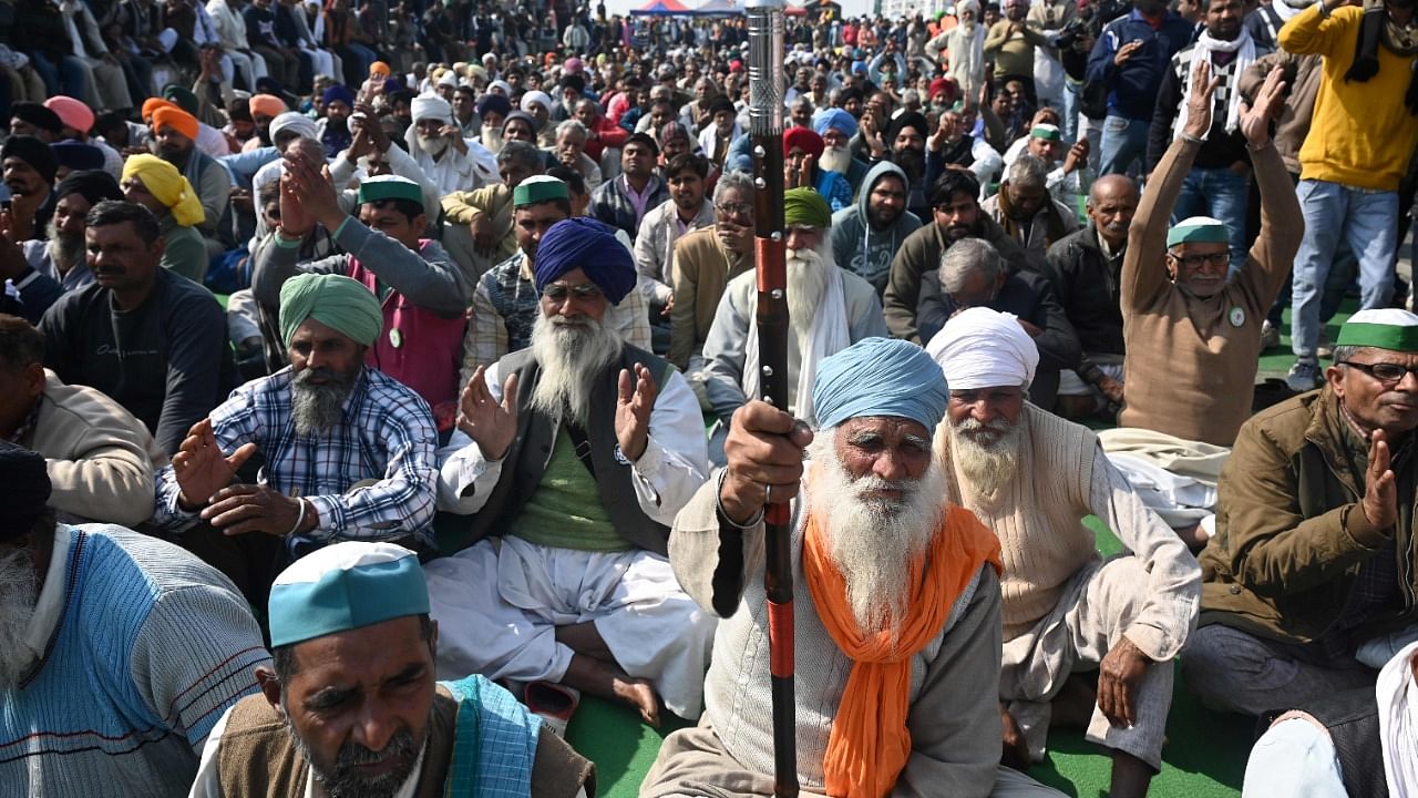 Farmers sit along a blocked highway during a protest against the central government's recent agricultural reforms at the Delhi-Uttar Pradesh state border in Ghazipur on January 30, 2021. Credit: AFP Photo