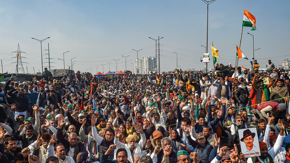 Farmers raise slogans at Ghazipur border as they observe a hunger strike on Mahatma Gandhi's death anniversary, during their ongoing agitation against Centre's farm reform laws. Credit: PTI Photo