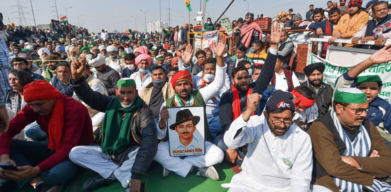 Farmers raise slogans at Ghazipur border as they observe a hunger strike on Mahatma Gandhi's death anniversary, during their ongoing agitation against Centre's farm reform laws, in New Delhi. Credit: PTI Photo