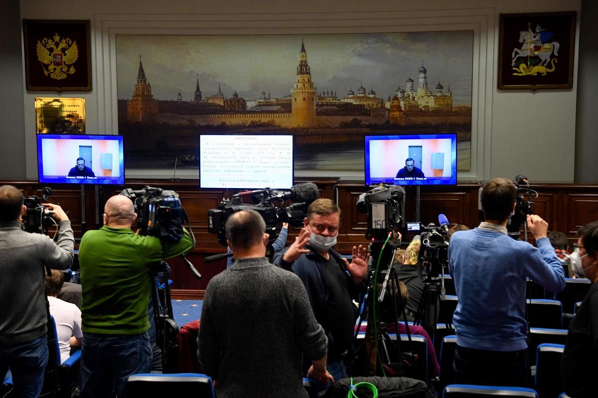 Opposition leader Alexei Navalny appears on screens set up at a hall of the Moscow Regional Court via a video link from Moscow's penal detention centre Number 1 (known as Matrosskaya Tishina) during a court hearing of an appeal against his arrest, in Krasnogorsk outside Moscow on January 28, 2021. Credit: AFP. 