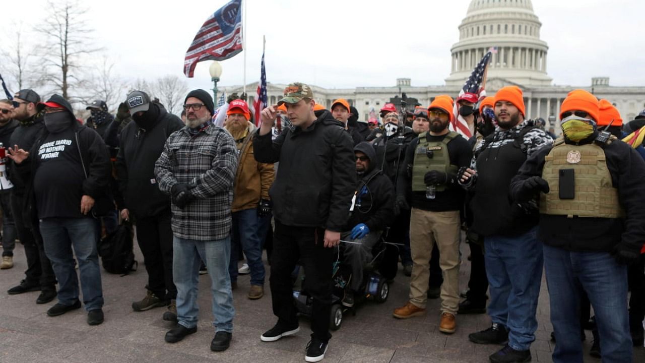 Proud Boys member Joe Biggs (front row second from left in grey plaid shirt) poses with other members before he was later arrested for involvement in the storming of the US Capitol building in Washington. Credit: Reuters.