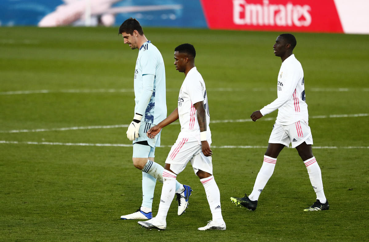 Real Madrid's Thibaut Courtois looks dejected with teammates after the match. Credit: Reuters. 