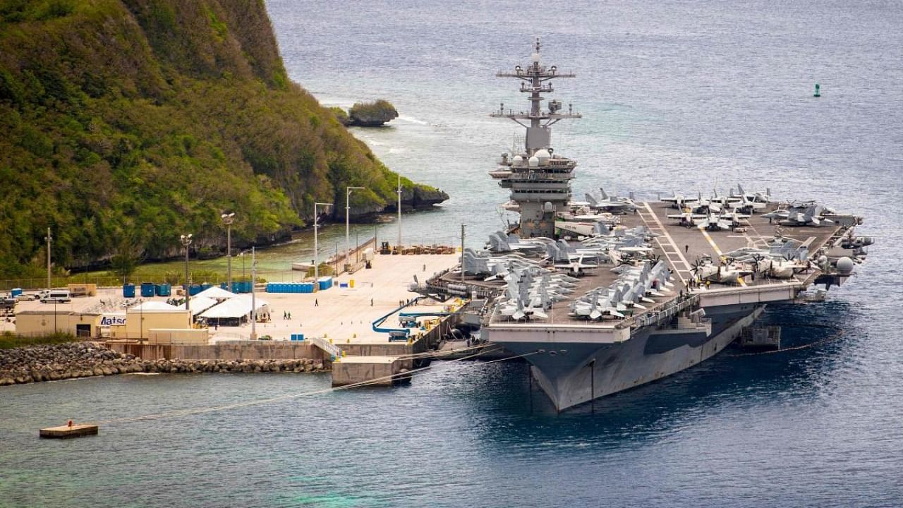 This file US Navy photo shows the aircraft carrier USS Theodore Roosevelt (CVN 71)as it is moored pier side at Naval Base Guam on May 15, 2020. Credit: AFP.