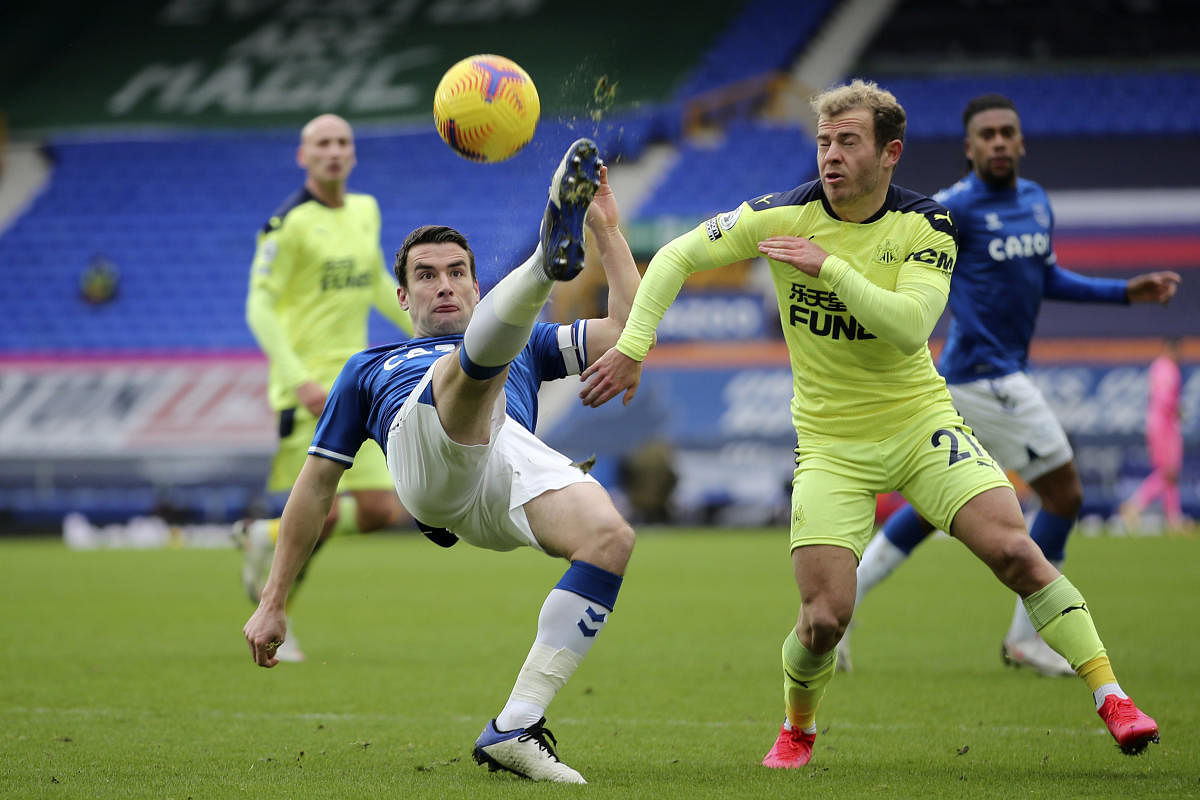 Everton's Seamus Coleman, left, clears the ball away from Newcastle's Ryan Fraser during the English Premier League soccer match between Everton and Newcastle United at Goodison Park, Liverpool. Credit: AP. 