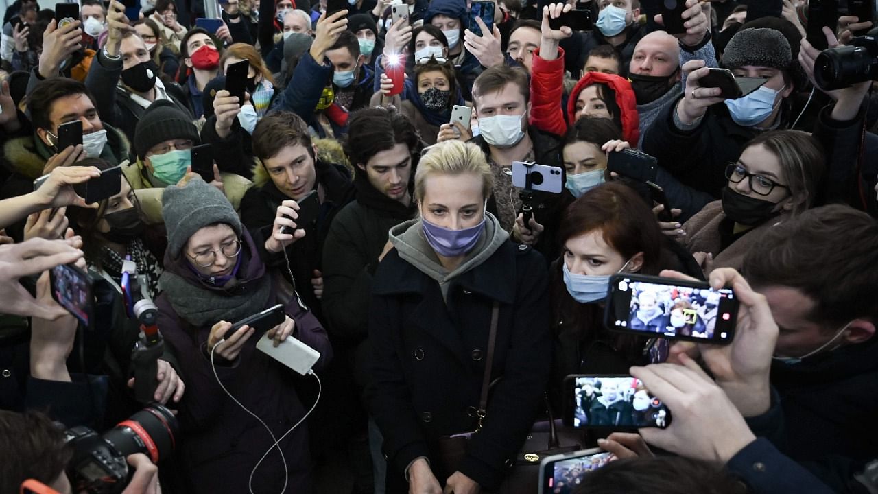 Opposition leader Alexei Navalny's wife Yulia Navalnaya (C) is seen surrounded by people as she leaves Moscow's Sheremetyevo airport upon the arrival from Berlin on January 17, 2021.