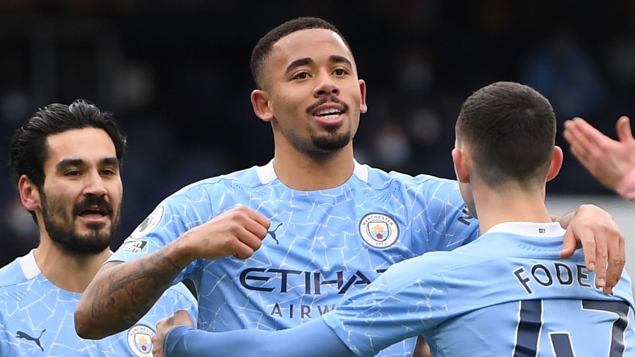 Manchester City's Brazilian striker Gabriel Jesus (C) celebrates scoring the opening goal during the English Premier League football match between Manchester City and Sheffield United at the Etihad Stadium in Manchester. Credit: Reuters Photo.