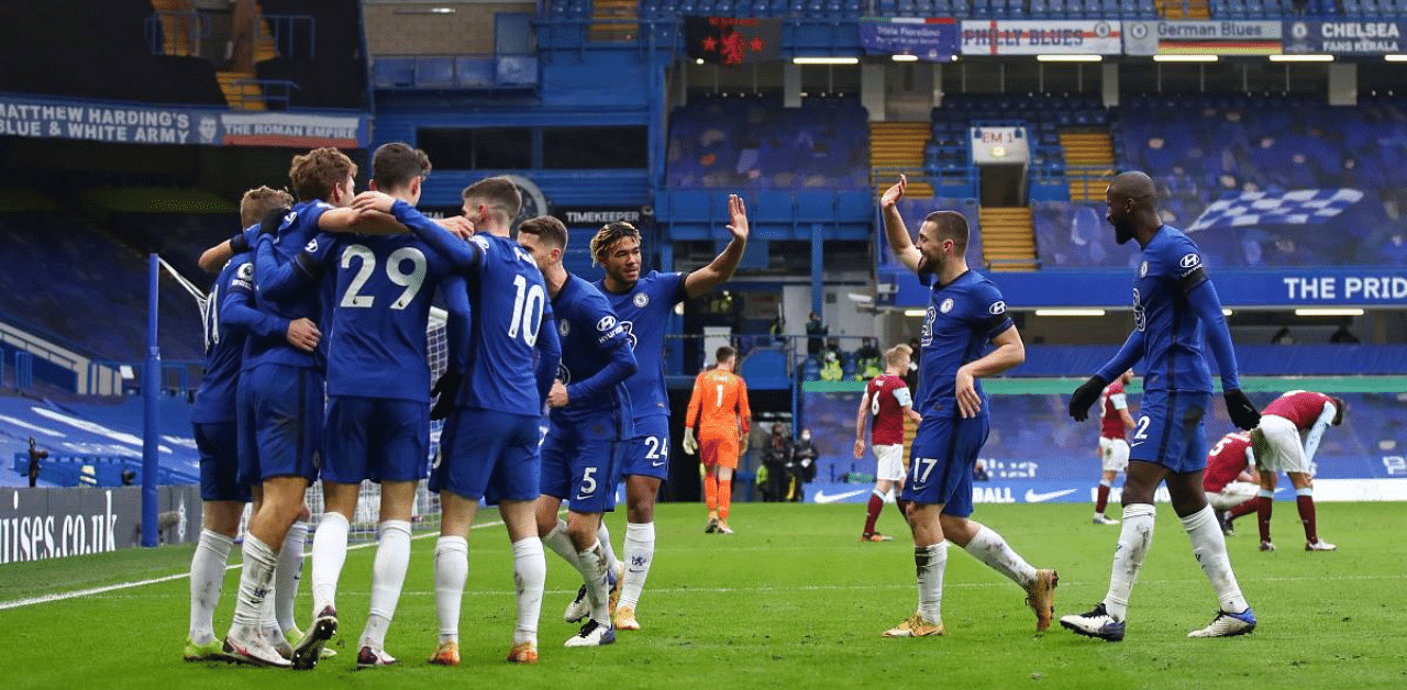 Chelsea's Spanish defender Marcos Alonso is mobbed by teammates after scoring his team's second goal during the English Premier League football match between Chelsea and Burnley. Credit: AFP Photo