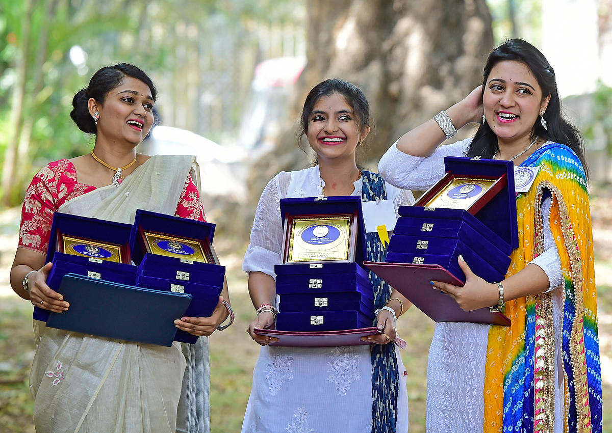 Gold medallists Chaithanya C (MCom), Aishwarya Srinivas (BBA) and Sheetal V Rao (MSc Biochemistry) are all smiles at the 55th annual convocation of Bangalore University on Saturday. DH PHOTOs/RANJU P