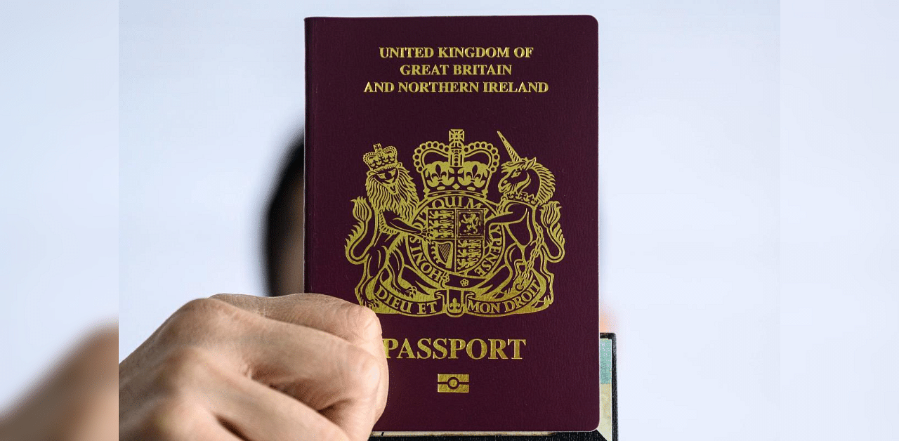 A person holds up a British National (Overseas) passport in Hong Kong on January 29, 2021. Credit: AFP file photo. 